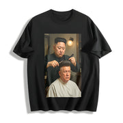 Kim Jong Un Cutting Donald Trump's Hair (Us) Cotton T-Shirt in Black